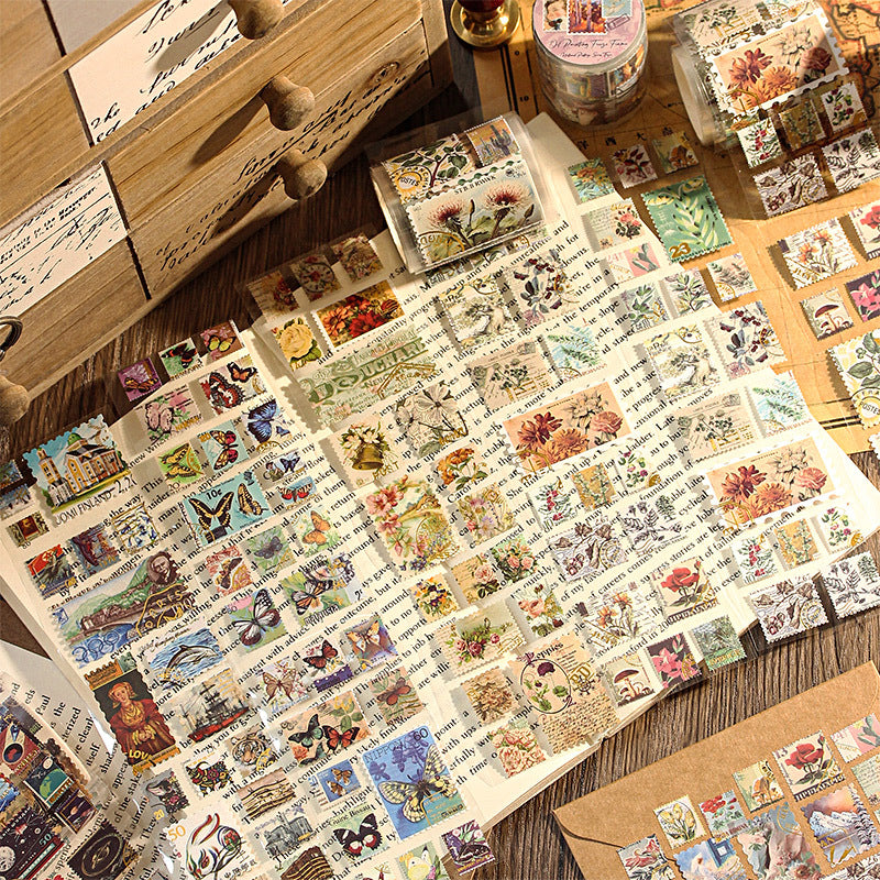 Yellowed letter paper, retro gold-stamped washi tape for DIY scene-making in bullet journals, bullet journal sticker rolls, plant and animal stickers, retro postage stamps.